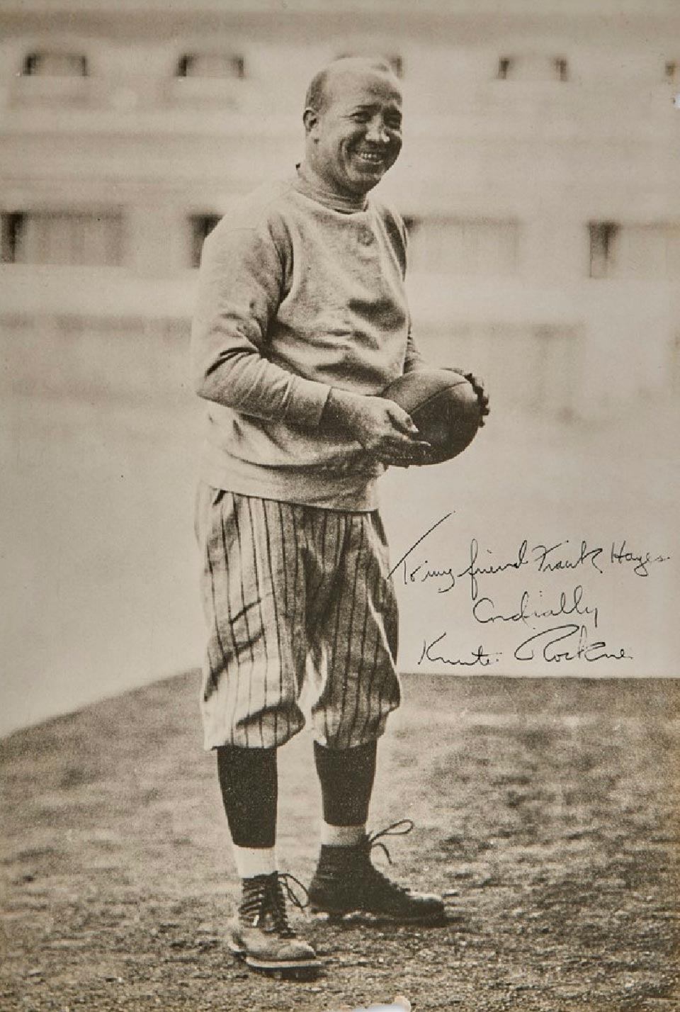 Knute Rockne - Autographed Photo An autographed photo of Knute posing with a football