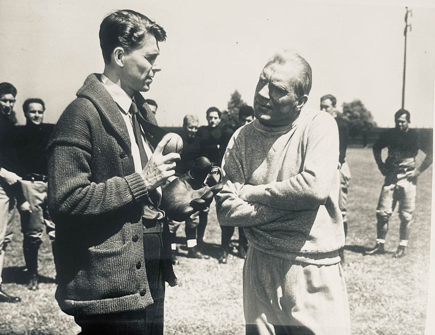 Screenshot from Movie Coach talking with a man holding a baseball and glove